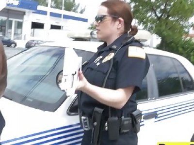 Two female cops take turns on a large black penis in a back of a truck